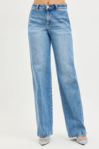Front view of RISEN medium-wash slouchy straight jeans showing the full legs and stitched hems.
