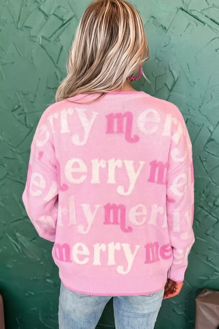 Back view of the pink Merry Me sweater worn with light-wash jeans.