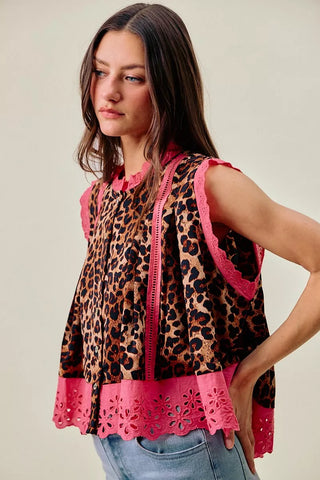 Angled front view of the SO ME leopard blouse showing pink lace edging and the button front.