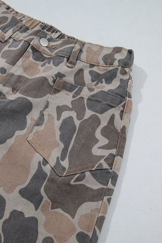 Close-up of a front patch pocket and contrast stitching on the camouflage jeans.