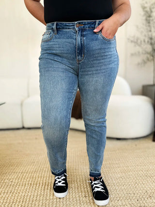 Full-length front view of Judy Blue 88818 release-hem jeans with black sneakers.