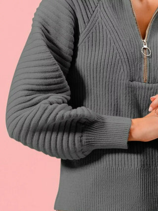 Close-up of the SO ME charcoal sweater's ribbed raglan sleeve, cuff and hem.