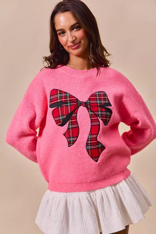 SO ME pink Christmas sweater front view showing long sleeves and the plaid bow.