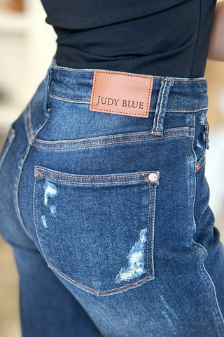 Close-up of Judy Blue 88819 jeans showing the branded waistband patch and distressed back pocket.