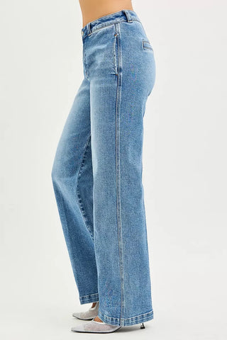 Side view of RISEN medium-wash slouchy straight jeans showing the leg seam and hem.