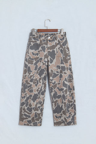 Front of camouflage ankle-length jeans on a hanger, showing patch pockets and a button waistband.
