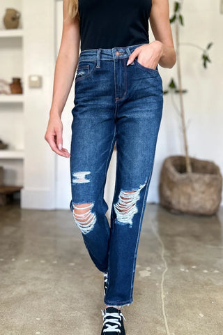 Front view of Judy Blue 88819 high-waist jeans showing ripped knees and raw hems with black sneakers.