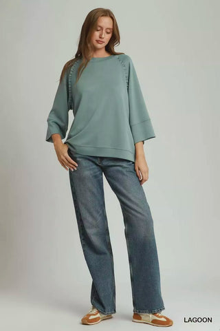 Full outfit view of the Umgee Lagoon three-quarter sleeve top with wide-leg blue jeans.