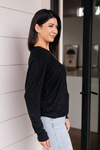 Black Very J Drive Downtown dolman-sleeve top, side view showing the dolman sleeve.