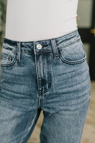 Judy Blue Carlie straight jeans in Everyday Indigo, close-up of button waist, pockets and zip fly.
