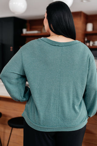 Teal Sew In Love Doesn't Compare V-neck top, back view showing the center seam.