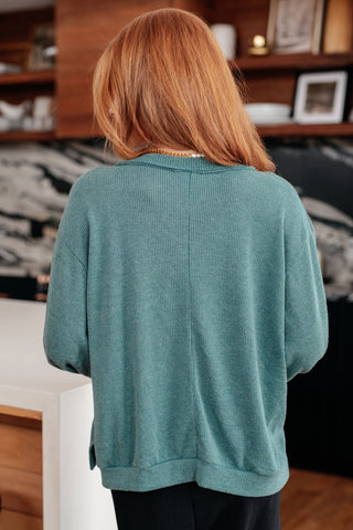Teal Sew In Love Doesn't Compare V-neck top, back view showing the banded hem.