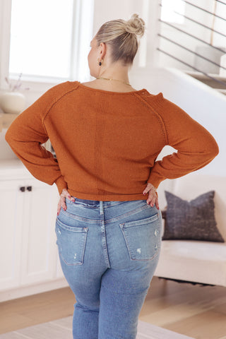 Rust Don't Be Difficult raglan pullover sweater, back view with light-wash jeans.
