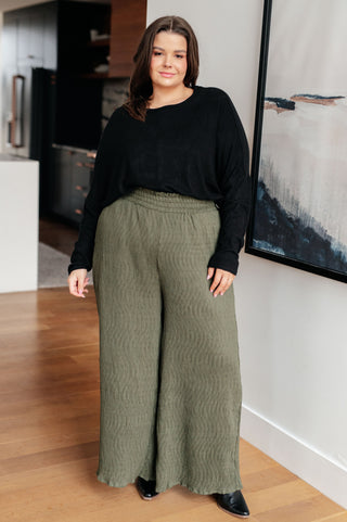 Black Very J Drive Downtown dolman-sleeve top, full outfit with olive wide-leg trousers.