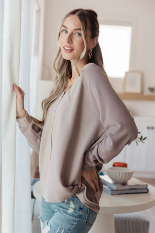 Taupe Sew In Love Less Conversation V-neck top, side view showing the relaxed hem.
