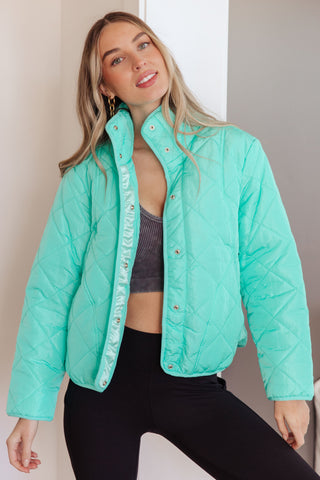 Aqua BiBi Slightly Distracted quilted puffer jacket, front view worn over a dark crop top.