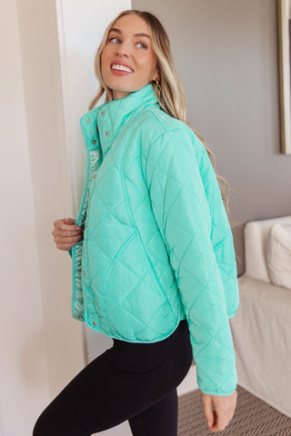 Aqua BiBi Slightly Distracted quilted puffer jacket, side view with black leggings.