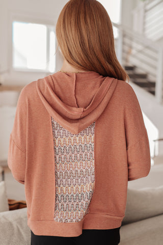 Rust Haptics Wave Hello mixed-print hoodie, back view showing the hood and patterned panel.