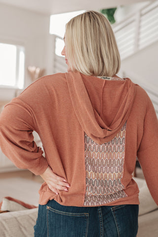 Rust Haptics Wave Hello mixed-print hoodie, back view showing the patterned center panel.