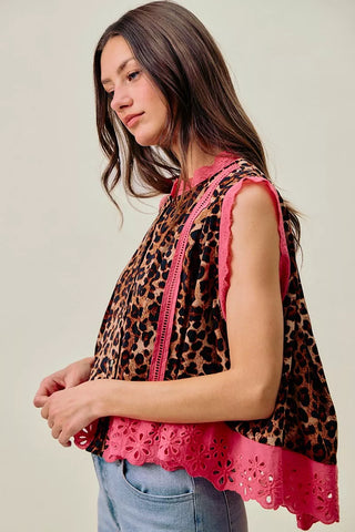 Side view of the SO ME leopard blouse showing the loose hem and bright pink lace edging.