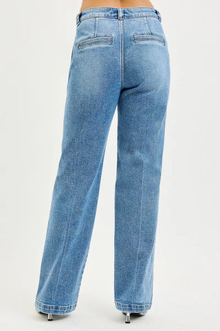 Back view of RISEN medium-wash straight jeans showing the rear pockets and straight legs.