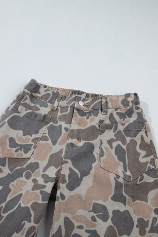 Close-up of the camouflage jeans' front waistband, button, belt loops and patch pockets.