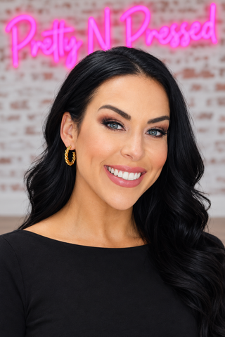 Natalie wearing Gold Medium Twist Hoops in a close-up view