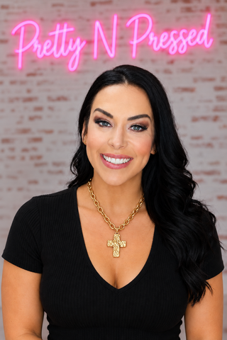 Natalie wearing the gold Hammered Cross Necklace with an oval-link chain.