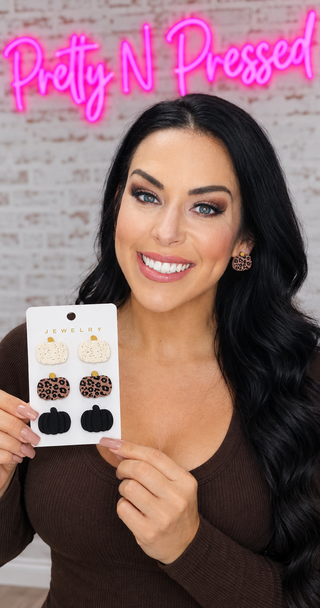 Natalie showing the three-pair cream, leopard-print and black pumpkin stud earring card.