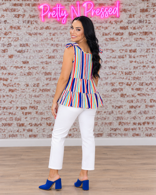 Natalie modeling the back construction and shoulder ties of the Multicolor Vertical Stripe Tie Bow Top