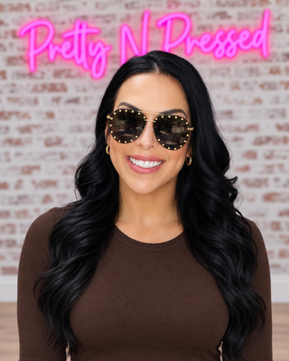 Natalie wearing gold and black Showstopper Studded Aviator Sunglasses at Pretty N Pressed Boutique
