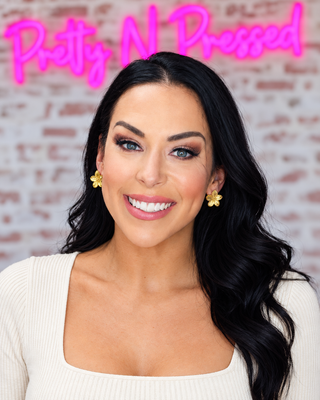 Natalie wearing dime-size gold Virginia flower earrings